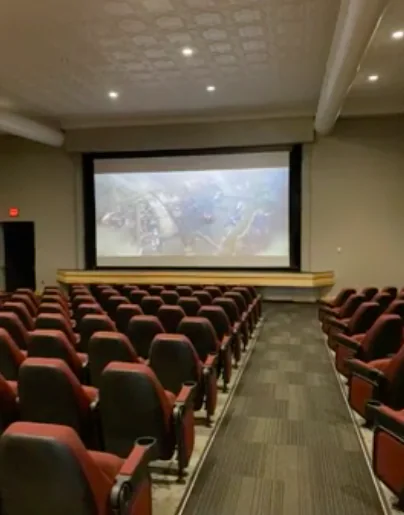 Inside the Lex Majestic Theatre auditorium with red rocker seats and the movie screen