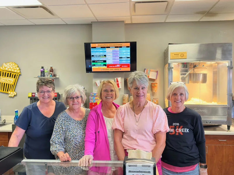 Community volunteers serving behind the Majestic concession counter